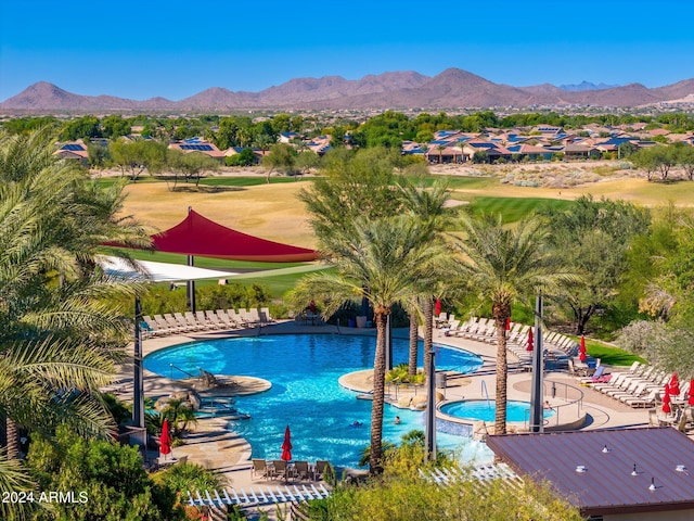 view of swimming pool featuring a patio area and a mountain view