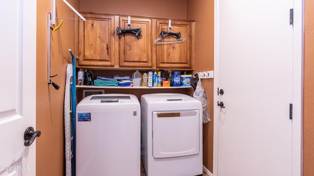 washroom with cabinets and washer and clothes dryer