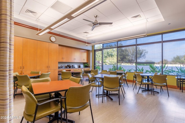 dining space featuring light wood-type flooring and ceiling fan