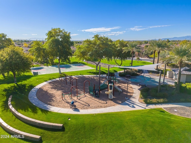 view of property's community with a playground and a yard