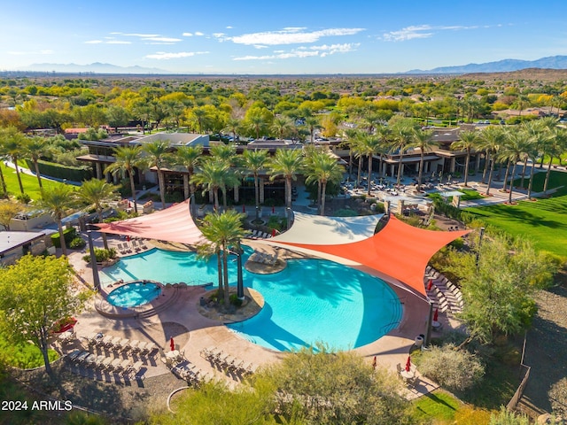 view of swimming pool with a patio area and a mountain view