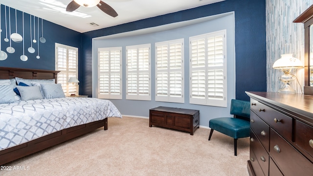 bedroom featuring light carpet and ceiling fan