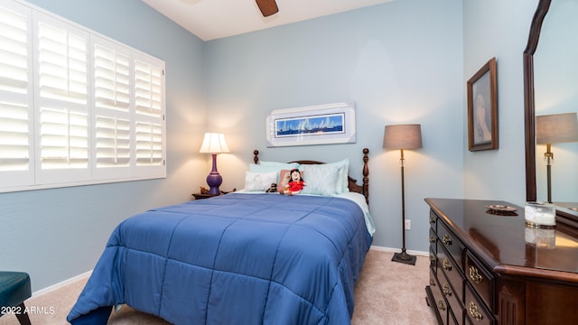 bedroom with light carpet and ceiling fan