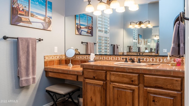 bathroom with vanity and tasteful backsplash