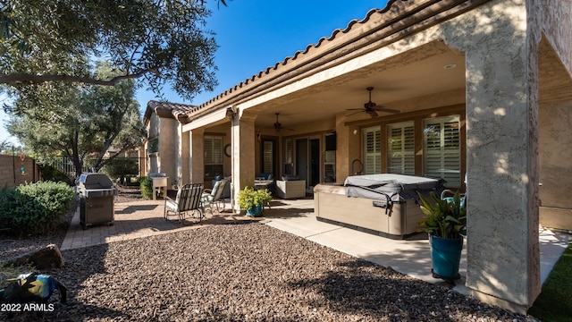 exterior space with a hot tub, a grill, and ceiling fan