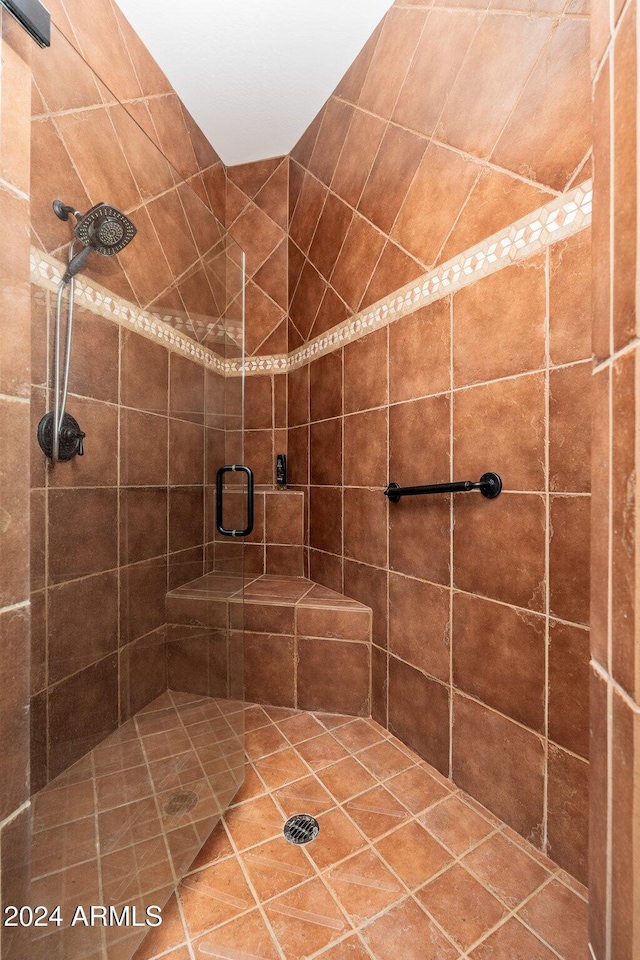 bathroom with a shower with door