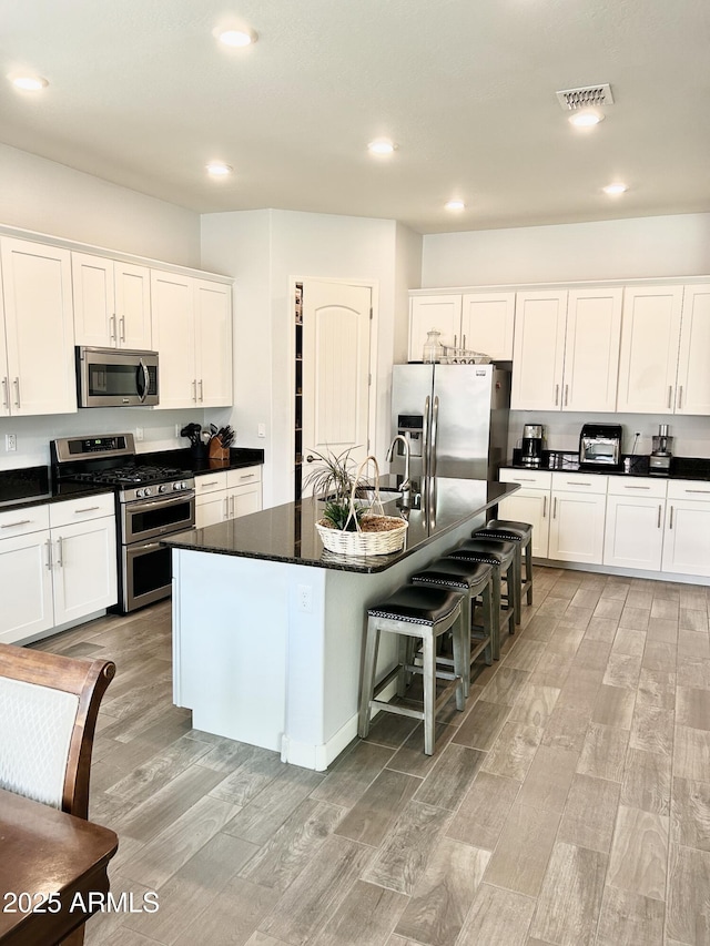4956 S Leisure Way, Gilbert, AZ 85298 - kitchen with appliances with stainless steel finishes, light wood finished floors, white cabinetry, and recessed lighting
