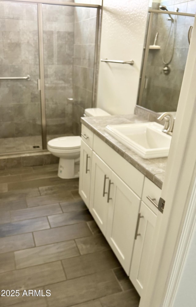 4956 S Leisure Way, Gilbert, AZ 85298 - full bathroom featuring vanity, a stall shower, toilet, and wood finish floors