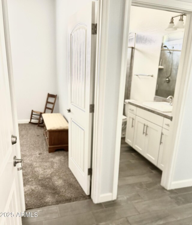 4956 S Leisure Way, Gilbert, AZ 85298 - hall with a sink, dark colored carpet, and baseboards