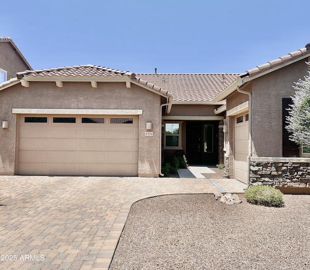 4956 S Leisure Way, Gilbert, AZ 85298 - view of front facade featuring an attached garage, stucco siding, a tiled roof, and driveway
