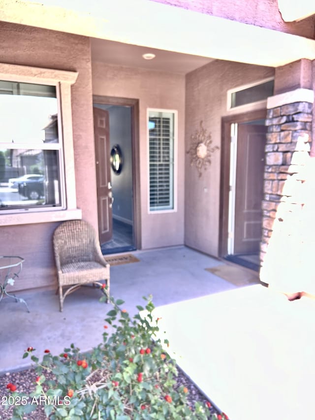 4956 S Leisure Way, Gilbert, AZ 85298 - view of exterior entry featuring stucco siding and a patio