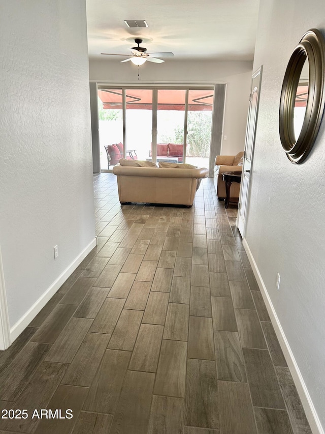 4956 S Leisure Way, Gilbert, AZ 85298 - hall with dark wood finished floors, healthy amount of natural light, and baseboards