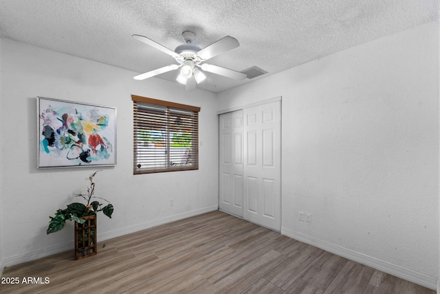 2804 N Nebraska St, Chandler, AZ 85225 - unfurnished bedroom featuring light wood-style floors, a textured ceiling, a closet, and baseboards