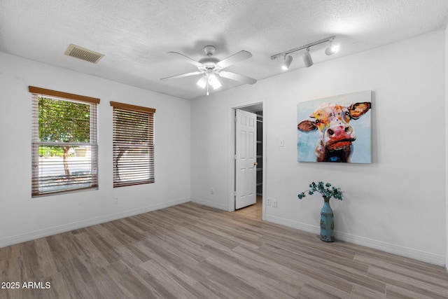 2804 N Nebraska St, Chandler, AZ 85225 - unfurnished room featuring a ceiling fan, a textured ceiling, light wood-style flooring, rail lighting, and baseboards