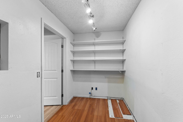2804 N Nebraska St, Chandler, AZ 85225 - laundry room featuring wood finished floors, a textured ceiling, and track lighting