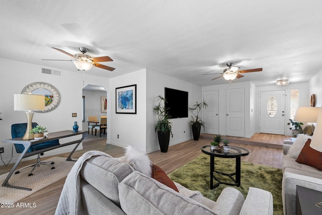 2804 N Nebraska St, Chandler, AZ 85225 - living area with ceiling fan, arched walkways, light wood-type flooring, and baseboards