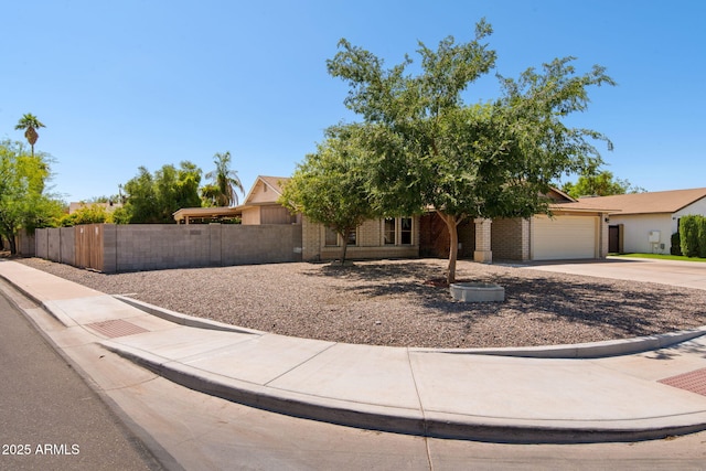 2804 N Nebraska St, Chandler, AZ 85225 - view of property hidden behind natural elements featuring a garage, concrete driveway, and brick siding