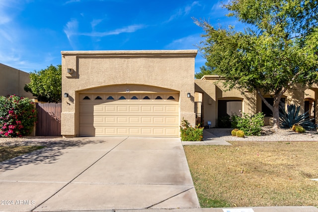 view of front facade with a front yard and a garage