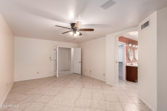 spare room with sink and ceiling fan