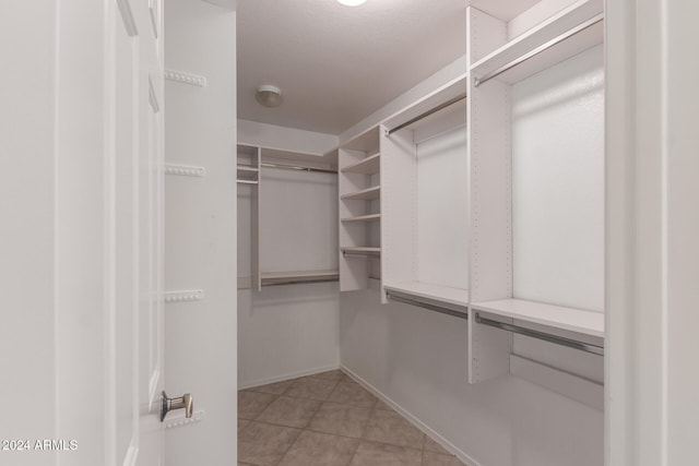 spacious closet with light tile patterned flooring