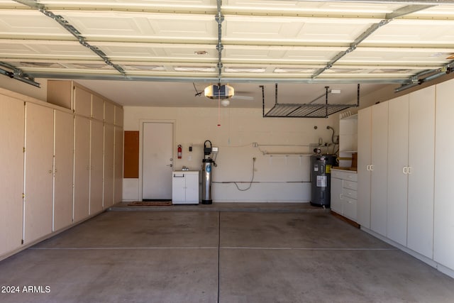 garage with a garage door opener and water heater