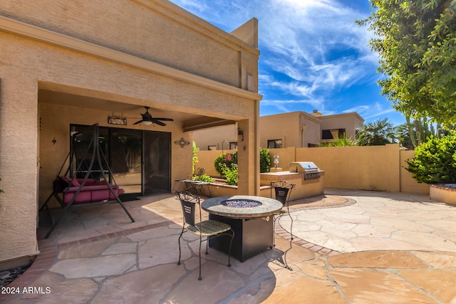 view of patio with exterior kitchen and ceiling fan