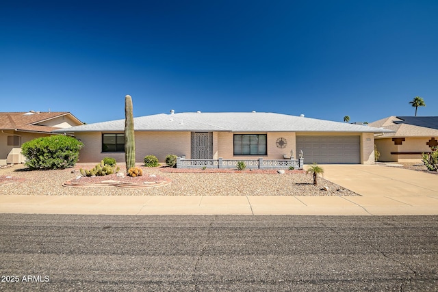 view of front of house with brick siding, concrete driveway, and an attached garage