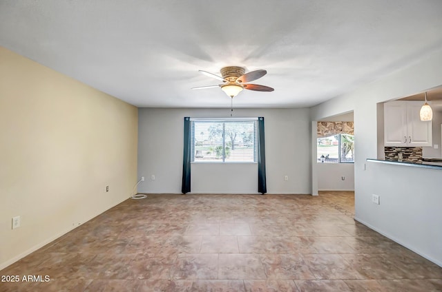 unfurnished room featuring a ceiling fan