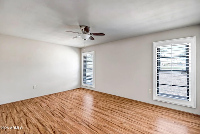 spare room with ceiling fan and wood finished floors