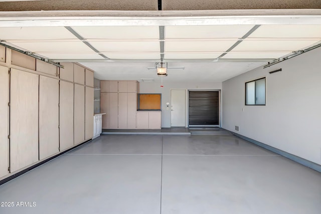 garage featuring a garage door opener and visible vents