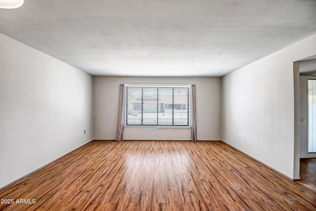 spare room featuring wood finished floors