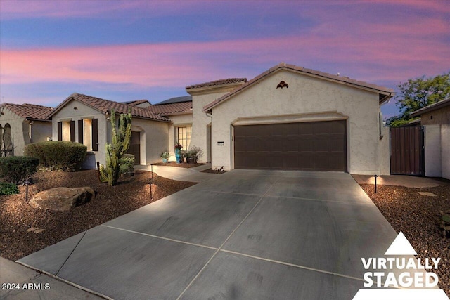 mediterranean / spanish house with a garage