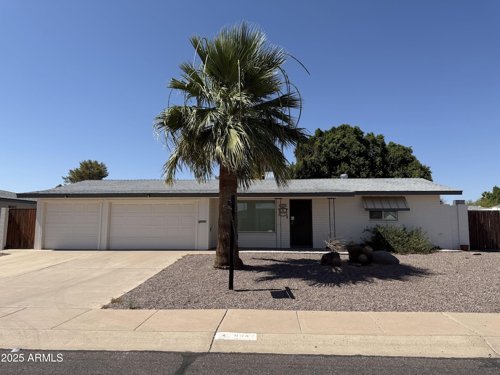 6048 E Des Moines St, Mesa, AZ 85205 - ranch-style house featuring a garage and concrete driveway