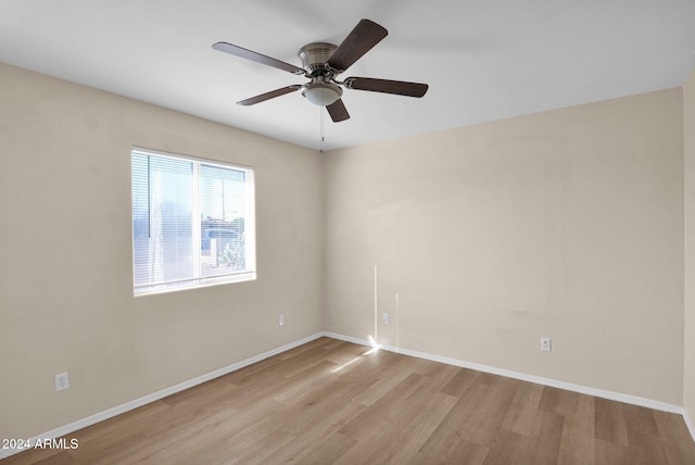 spare room featuring ceiling fan and light wood-type flooring