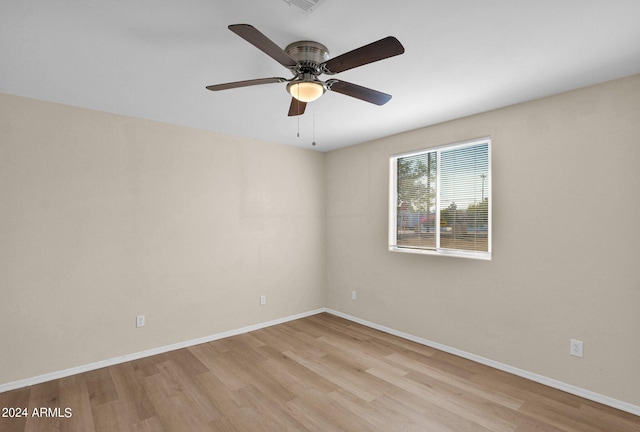 spare room featuring light hardwood / wood-style flooring and ceiling fan