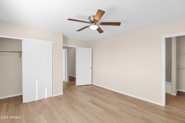 unfurnished bedroom with a closet, light hardwood / wood-style floors, connected bathroom, and ceiling fan