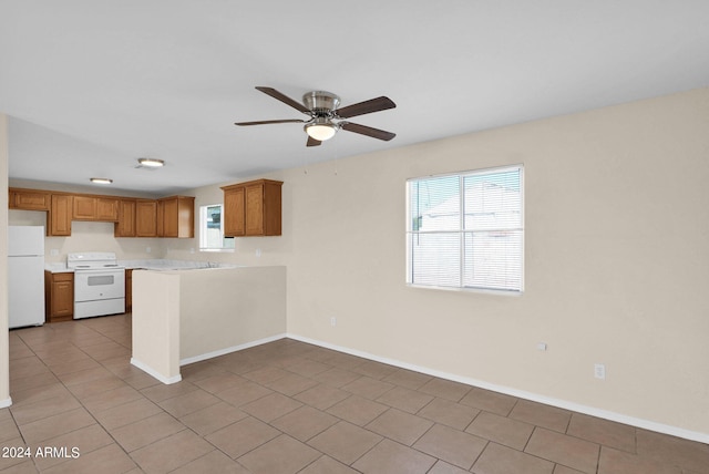 kitchen with ceiling fan, kitchen peninsula, light tile patterned floors, and white appliances