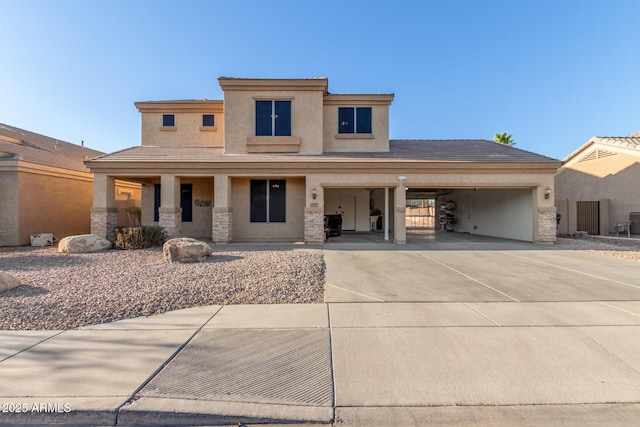 prairie-style house with concrete driveway, a tile roof, stucco siding, stone siding, and an attached garage