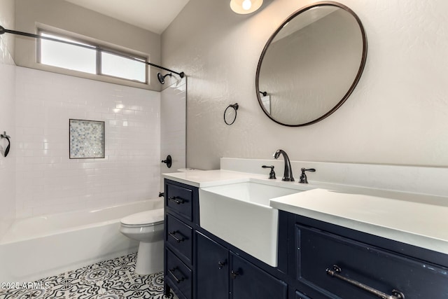 full bathroom with tiled shower / bath, vanity, toilet, and tile patterned floors