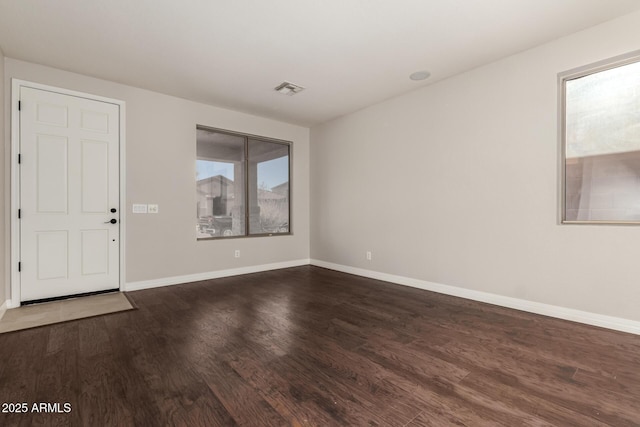 foyer entrance featuring dark wood-type flooring