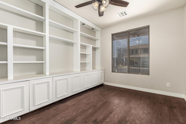 spare room with dark hardwood / wood-style floors and ceiling fan