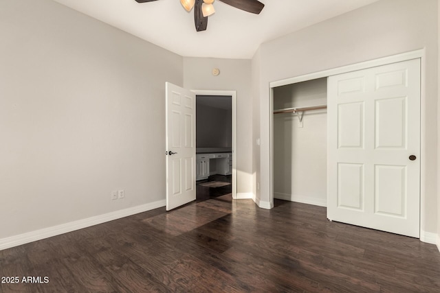 unfurnished bedroom with a closet, dark hardwood / wood-style floors, and ceiling fan