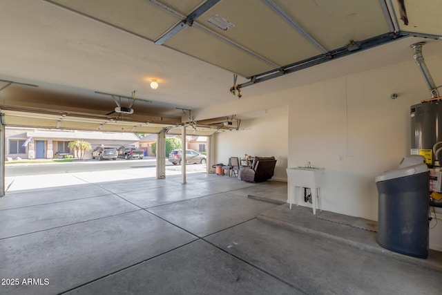 garage with a garage door opener and water heater