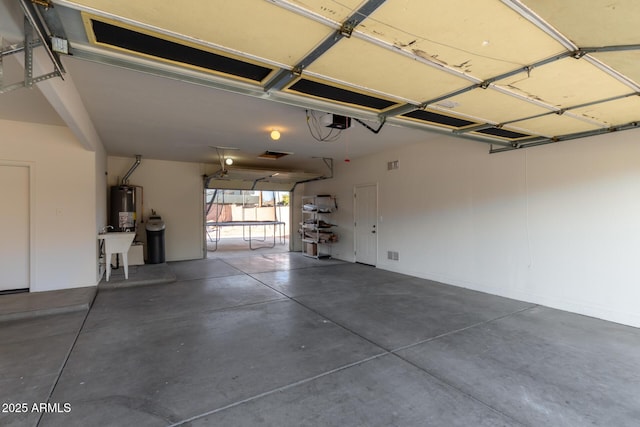 garage with a garage door opener and water heater