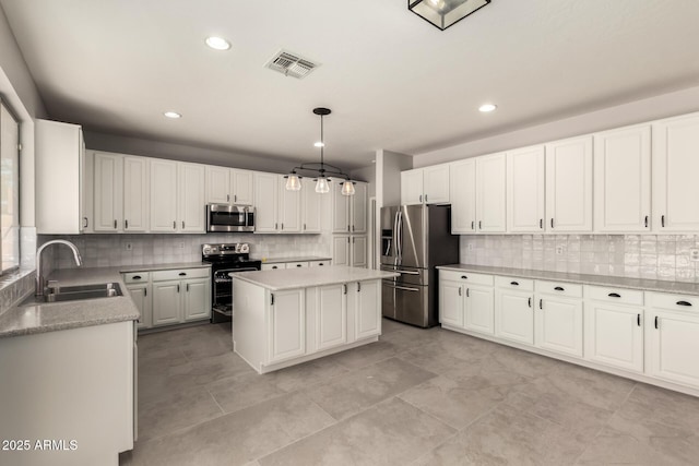 kitchen with pendant lighting, sink, white cabinets, a center island, and stainless steel appliances