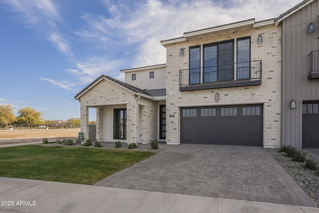 view of front of house featuring a garage and a front lawn