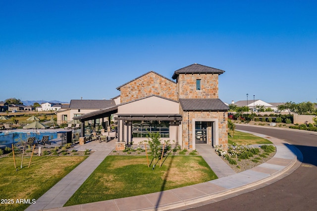 view of front of home with a front lawn and a patio