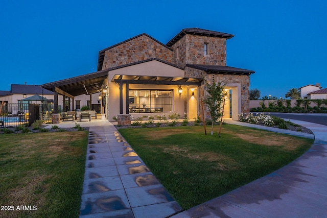 view of front of home with a patio, outdoor lounge area, and a yard