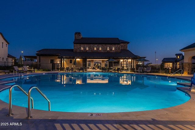 pool at night with a patio