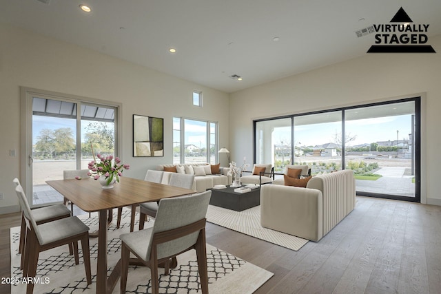 dining space with hardwood / wood-style flooring